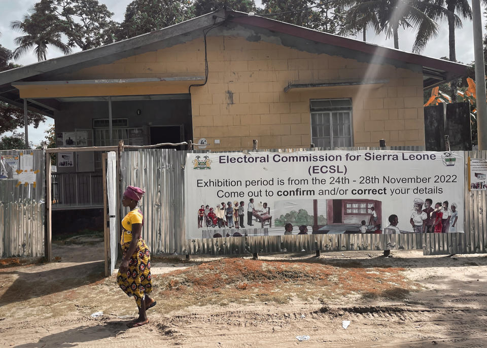 A woman walks past a polling station in Freetown, Sierra Leone, on June 15, 2023. With mounting frustration due to an ailing economy, rising unemployment and looming deadly protests, Sierra Leoneans are heading to the polls on Saturday, June 24 2023, to select their next president. (AP Photo/TJ Bade)