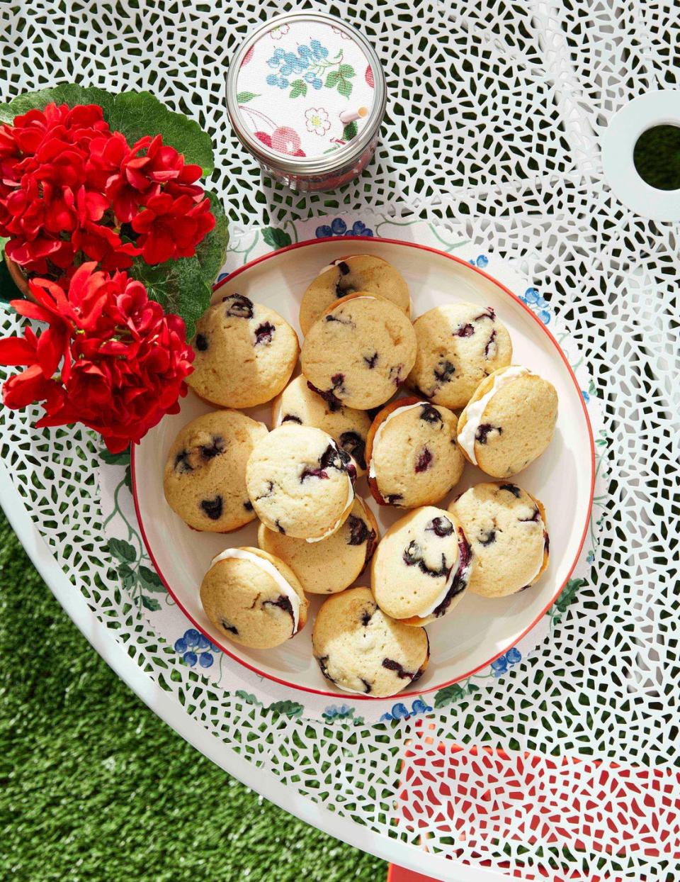 blueberry whoopie pies on a white plate on a table outside