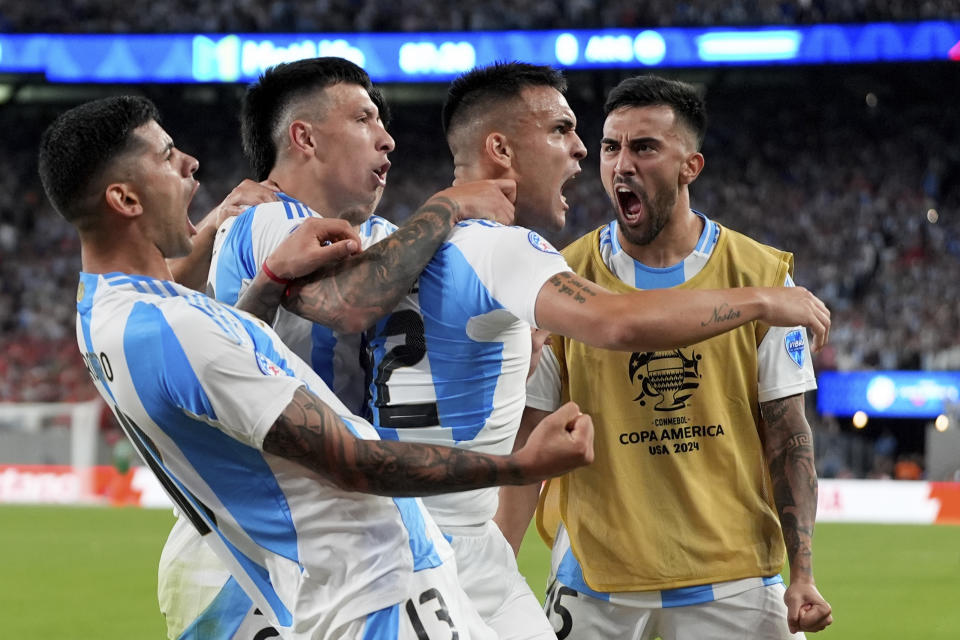 Argentina's Lautaro Martinez, second from right, celebrates scoring his side's opening goal against Chile during a Copa America Group A soccer match in East Rutherford, N.J., Tuesday, June 25, 2024.