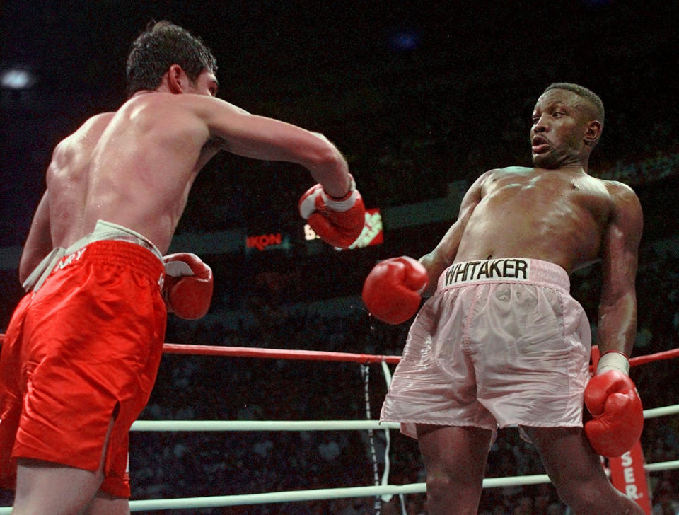 FILE - In this April 12, 1997, file photo, Pernell Whitaker, right, leans away from a punch by Oscar De La Hoya during their WBC Welterweight Championship fight at Thomas & Mack Center in Las Vegas. De La Hoya won by unanimous decision. Former boxing champion Pernell Whitaker has died after he was hit by a car in Virginia. He was 55. Police in Virginia Beach on Monday say Whitaker was a pedestrian when struck by the car Sunday night, July 14, 2019. The driver remained on the scene, where Whitaker was pronounced dead. (AP Photo/Eric Draper, File)