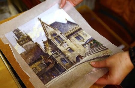 An employee puts away a watercolour of the old registry office in Munich by former German dictator Adolf Hitler at Weidler auction house in Nuremberg November 18, 2014. REUTERS/Kai Pfaffenbach