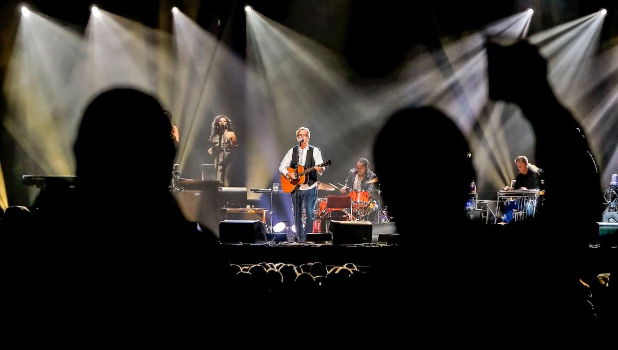 Fans are silhouetted March 20, 2013, as they cheer while Eric Clapton performs during a concert at the then-Chesapeake Energy Arena (now Paycom Center) in Oklahoma City.