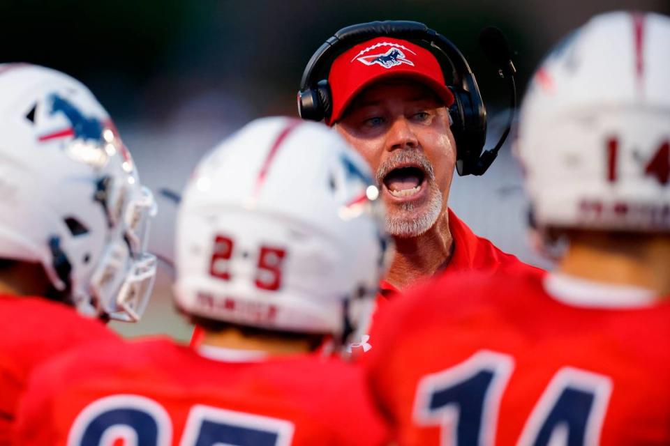 Providence Day’s head coach Chad Grier speaks to the team during a game against Weddington at Providence Day in Charlotte, N.C., Friday, Aug. 26, 2022.