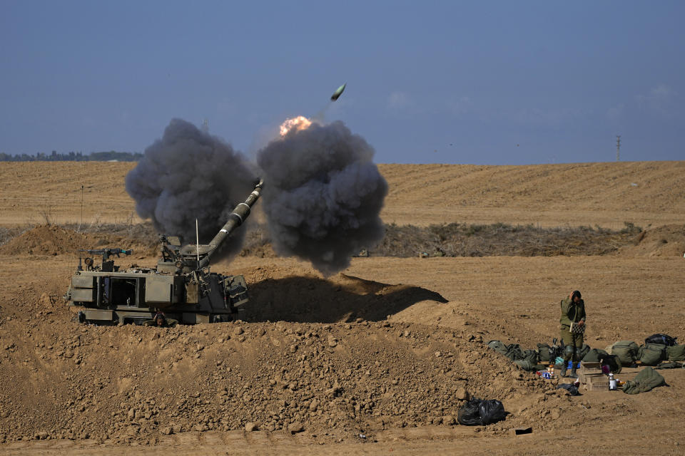 An Israeli mobile artillery unit fires a shell from southern Israel towards the Gaza Strip, in a position near the Israel-Gaza border, Sunday, Oct. 15, 2023. (AP Photo/Ohad Zwigenberg)