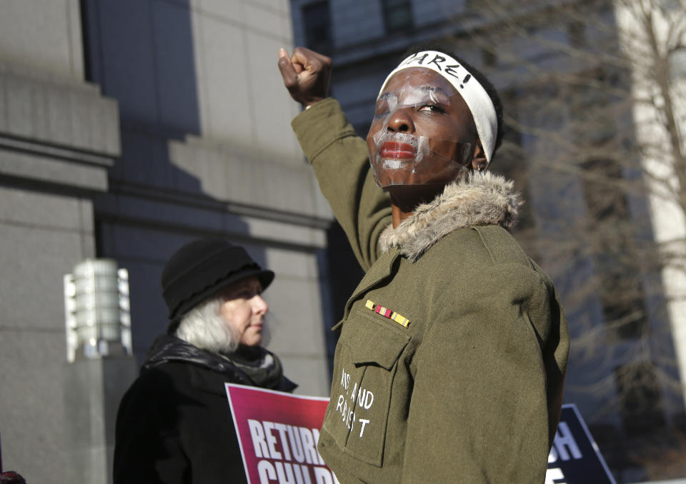 Therese Okoumou poses for pictures and rallies with supporters before her sentencing in New York, Tuesday, March 19, 2019. Okoumou was convicted of trespassing and other offenses after she climbed the base of the Statue of Liberty on July 4, 2018. (AP Photo/Seth Wenig)