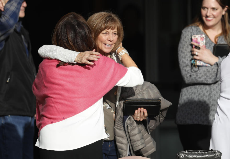 Roxanne Ballard, left, greets another woman as she arrives to attend a faith-based memorial service for the victims of the massacre at Columbine High School nearly 20 years earlier, at a community church, Thursday, April 18, 2019, in Littleton, Colo. (AP Photo/David Zalubowski)