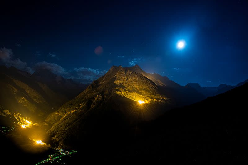 The mountain chains of Veisivi and Dent de Perroc are illuminated to celebrate Swiss National Day in Evolene