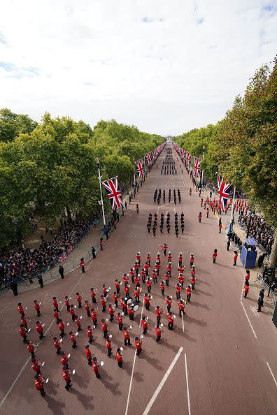 LONDON, ENGLAND - SEPTEMBER 19: The State Gun Carriage carries the coffin of Queen Elizabeth II, draped in the Royal Standard with the Imperial State Crown and the Sovereign's orb and sceptre, in the Ceremonial Procession following her State Funeral at Westminster Abbey on September 19, 2022 in London, England.  Elizabeth Alexandra Mary Windsor was born in Bruton Street, Mayfair, London on 21 April 1926. She married Prince Philip in 1947 and ascended the throne of the United Kingdom and Commonwealth on 6 February 1952 after the death of her Father, King George VI. Queen Elizabeth II died at Balmoral Castle in Scotland on September 8, 2022, and is succeeded by her eldest son, King Charles III. (Photo by Zac Goodwin - WPA Pool/Getty Images)