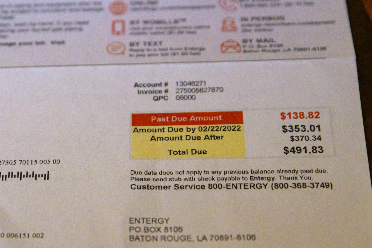 An electricity bill for Carolyn Peters is photographed at her home in New Orleans, Friday, Feb. 4, 2022. Peters, who lives on a fixed retirement income has high utility bills including late fees from Entergy, a major utility provider in Louisiana and three other Southern states, causing her to choose between medication and other bills. (AP Photo/Matthew Hinton)