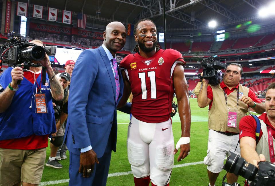 Jerry Rice greets then Arizona Cardinals wide receiver Larry Fitzgerald (11) during a game on Sep. 29, 2019, in Glendale, Ariz.