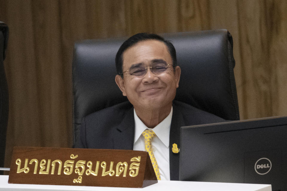 Thailand's Prime Minister Prayuth Chan-ocha smiles before answering a question at parliament in Bangkok, Thailand, Wednesday, Sept. 18, 2019. Prayuth has come under fire in a parliamentary debate because he omitted a key phrase in taking his oath of office in July, but dodged opposition demands to explain why he had left it out. (AP Photo/Sakchai Lalit)