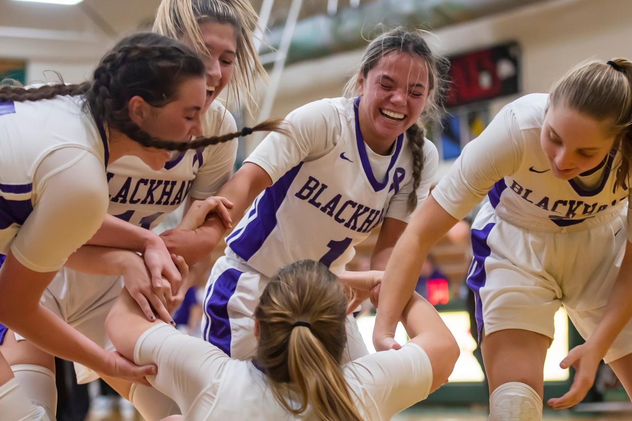 Blackhawk's Casey Nixon gets helped off the ground by her smiling teammates after Nixon stood her ground under the basket and a charge was called on Beaver during their game Thursday at Blackhawk High School..[Lucy Schaly/For BCT]