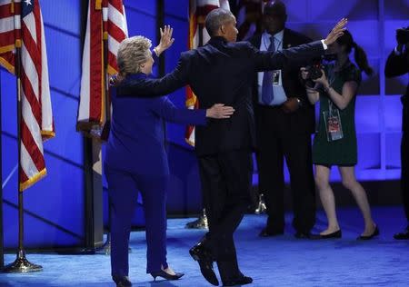 U.S. President Barack Obama and Democratic presidential nominee Hillary Clinton appear onstage together after his speech on the third night at the Democratic National Convention in Philadelphia, Pennsylvania, U.S. July 27, 2016. REUTERS/Mike Segar