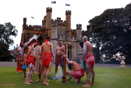 Australian Aborigines and Torres Strait Islanders wearing traditional dress stand in front of Government House after performing in a welcoming ceremony in Sydney, Australia, June 28, 2017. REUTERS/David Gray