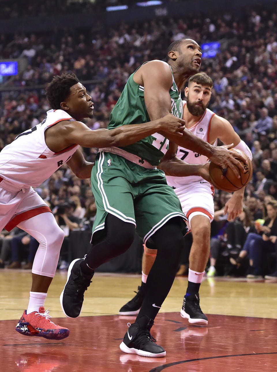 Toronto Raptors guard Kyle Lowry (7) defends as Boston Celtics forward Al Horford (42) as he drives to the basket during the first half of an NBA basketball game, Friday, Oct. 19, 2018 in Toronto. (Frank Gunn/The Canadian Press via AP)