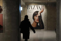 A visit0r walks by a cover from Harper's Bazar magazine as part of the exhibition « Harper's Bazaar, First in Fashion » at the The Musée des Arts Décoratifs, in Paris, Thursday, Feb. 27, 2020. The Musée des Arts Décoratifs is re-opening its entirely renovated 1,300 square meter Fashion Galleries, the world's largest fashion exhibition space. (AP Photo/Thibault Camus)