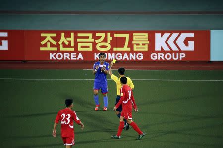 A player from the Philippines receives a yellow card in front of an advertising board while playing against North Korea in their team's preliminary 2018 World Cup and 2019 AFC Asian Cup qualifying soccer match at the Kim Il Sung Stadium in Pyongyang October 8, 2015. REUTERS/Damir Sagolj