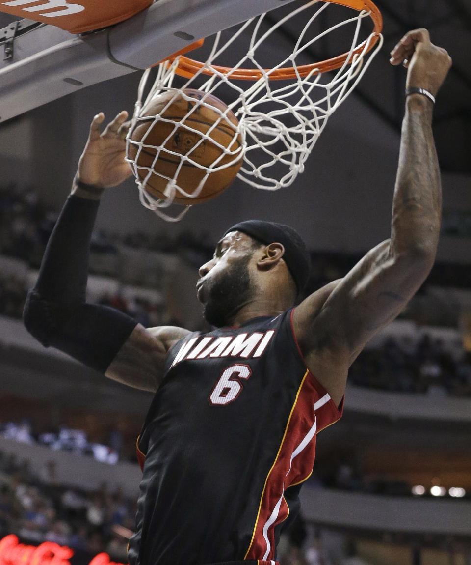 Miami Heat forward LeBron James dunks during the first half of an NBA basketball game against the Dallas Mavericks on Tuesday, Feb. 18, 2014, in Dallas. (AP Photo/LM Otero)