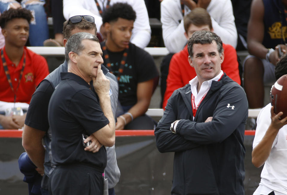Under Armour CEO Kevin Plank, right, stands on the Maryland sideline alongside Maryland basketball head coach Mark Turgeon during an NCAA college football game between Maryland and Northwestern in College Park, Md., Saturday, Oct. 14, 2017. (AP Photo/Patrick Semansky)