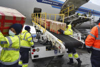 FILE - In this April 10, 2020, file photo, wearing protective masks ground crew at the Los Angeles International airport unload supplies of medical personal protective equipment, PPE, from a China Southern Cargo plane upon it's arrival. States are spending billions of dollars stocking up on medical supplies like masks and breathing machines during the coronavirus pandemic. An Associated Press survey of all 50 states found a hodgepodge of public information about the purchase of masks, gloves, gowns and other hard-to-get equipment for medical and emergency workers. (AP Photo/Richard Vogel, File)