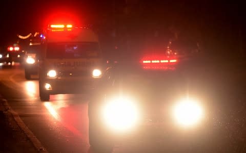 An ambulance reportedly carrying some of the rescued boys leaves the Tham Luang cave area for hospital - Credit: Tang Chhin Sothy/AFP