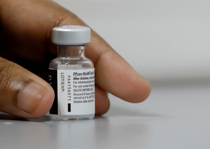 FILE PHOTO: A medical worker prepares to dilute a vial of Pfizer-BioNTech vaccine at a coronavirus disease (COVID-19) vaccination center in Singapore