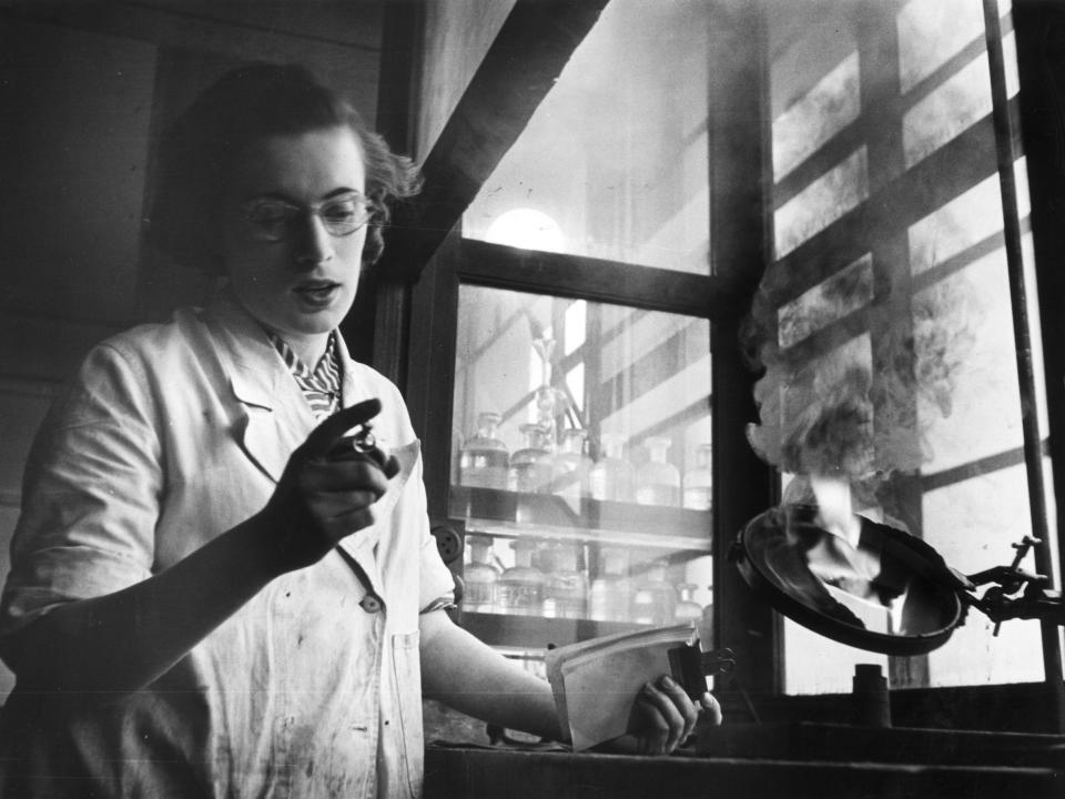 A woman assesses the burning properties of coal for the railway in 1953.