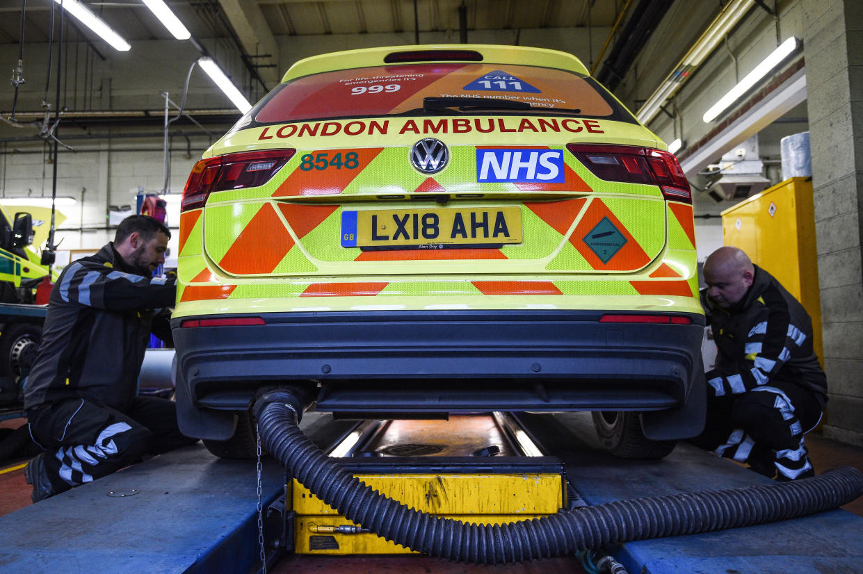 AA mechanics check the tires of an ambulance, at the London Ambulance Service workshop in Fulham, London.