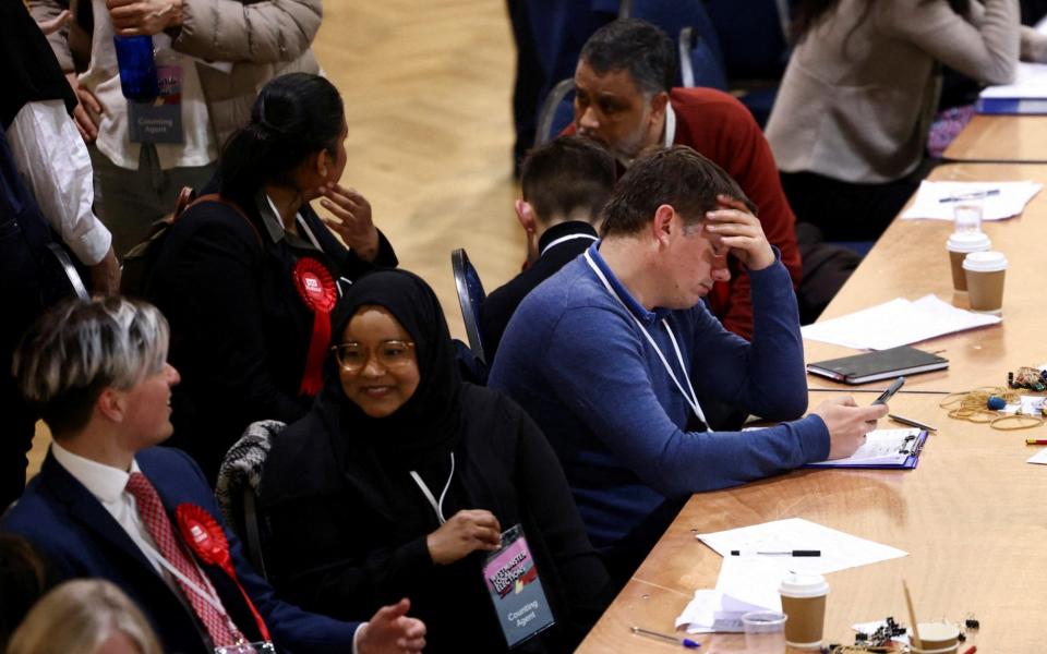 Attendees talk to each other during the counting process at the Westminster City Council local elections, at Lindley Hall in Westminster - REUTERS