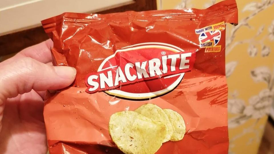 A crisp packet in a woman's hand