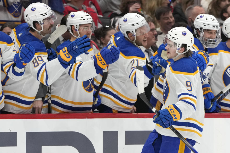 Buffalo Sabres left wing Zach Benson (9) is congratulated by teammates after scoring a goal in the first period of an NHL hockey game against the Washington Capitals, Wednesday, Nov. 22, 2023, in Washington. (AP Photo/Mark Schiefelbein)