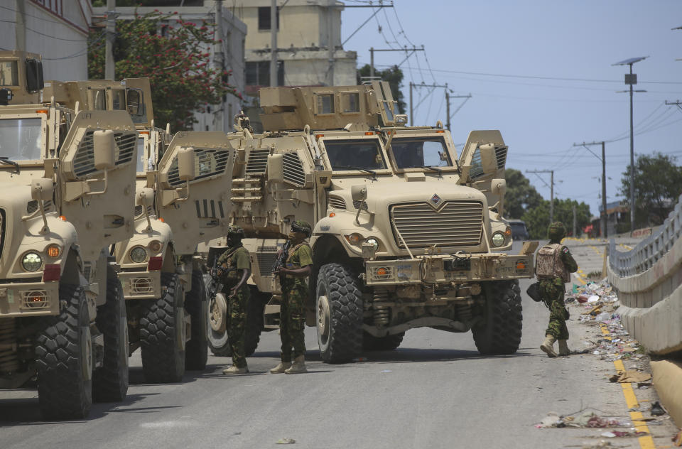 Kenyan police officers, part of a UN-backed multinational, work to tow away a broken down armored car during an operation in the Delmas neighborhood of Port-au-Prince, Haiti, Wednesday, Sept. 4, 2024. (AP Photo/Odelyn Joseph)