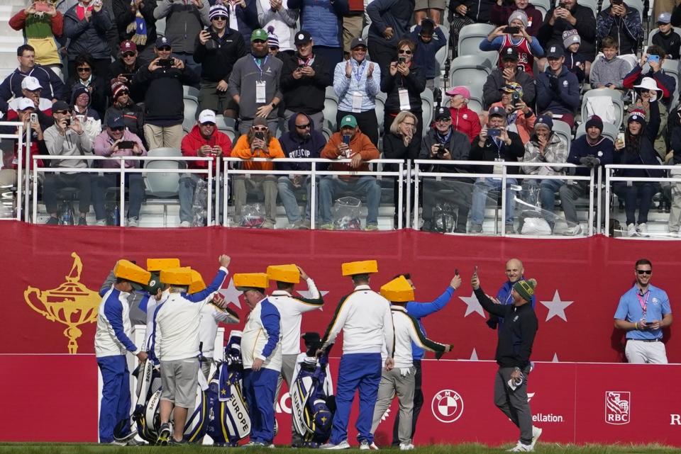 Team Europe wears cheeseheads on the first tee during a practice day at the Ryder Cup at the Whistling Straits Golf Course Wednesday, Sept. 22, 2021, in Sheboygan, Wis. (AP Photo/Jeff Roberson)