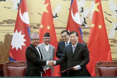 Chinese Premier Li Keqiang (Centre-R) with Nepal Prime Minister Khadga Prasad Sharma Oli (Centre-L) attend a signing ceremony at the Great Hall of the People in Beijing, China March 21, 2016. REUTERS/Lintao Zhang/Pool