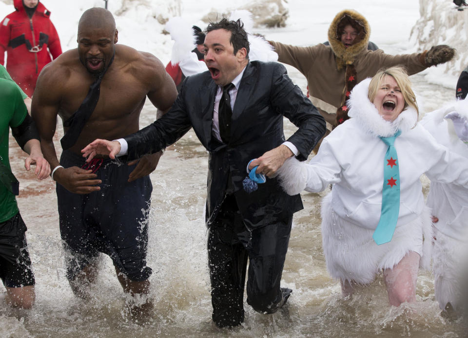 "The Tonight Show" host Jimmy Fallon, center, exits the water during the Chicago Polar Plunge, Sunday, March 2, 2014, in Chicago. Fallon joined Chicago Mayor Rahm Emanuel in the event. (AP Photo/Andrew A. Nelles)