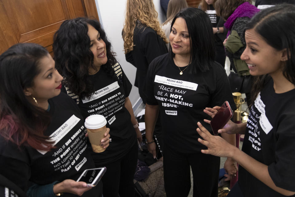 Women opposed to the Neomi Rao, President Donald Trump's nominee for a seat on the D.C. Circuit Court of Appeals, stand outside the Senate Judiciary Committee as she appears for her confirmation hearing, on Capitol Hill in Washington, Tuesday, Feb. 5, 2019. Liberal activists are targeting Rao for what they call her extreme views on race, sexual assault and LGBT rights. (AP Photo/J. Scott Applewhite)