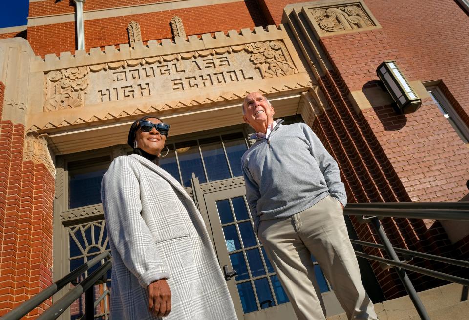 Ron Bradshaw and Gina Sofola are shown at the entrance to the historic Douglass High School, later known as Page Woodson School.