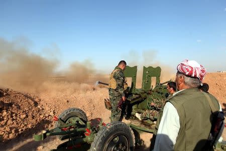 Kurdish Peshmerga forces fire a weapon during clashes with Islamic State militants in a village east of Mosul, Iraq, May 29, 2016. REUTERS/Azad Lashkari