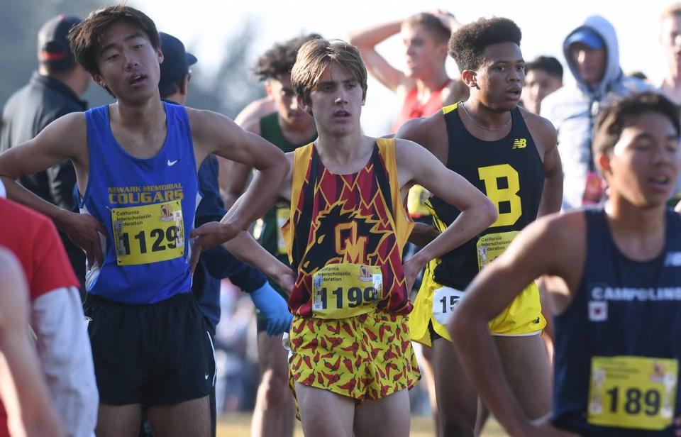 Oakdale’s Dax Daley, center, after finishing the Boys Division I race at the CIF state cross country championships held at Woodward Park Saturday, Nov. 27, 2021 in Fresno.