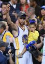 <p>Stephen Curry #30 of the Golden State Warriors celebrates holding his daughter Ryan after defeating the Cleveland Cavaliers 129-120 in Game 5 to win the 2017 NBA Finals at ORACLE Arena on June 12, 2017 in Oakland, California. </p>