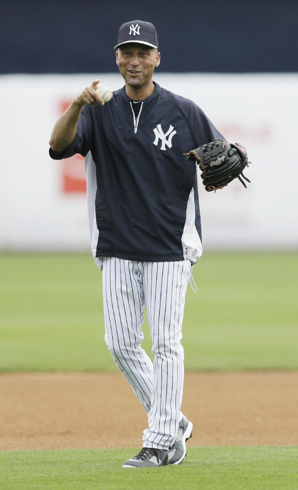 New York Yankees shortstop Derek Jeter warms up before an exhibition baseball game against the Pittsburgh Pirates Thursday, Feb. 27, 2014, in Tampa, Fla. (AP Photo/Charlie Neibergall)