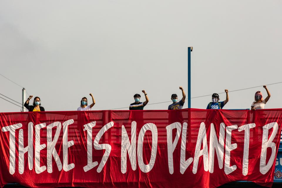 Environmental activists, wearing face masks and face shields to protect against COVID-19, take part in a rally coinciding with global protests on the climate crisis on September 25, 2020 in Manila, Philippines. The Global Climate Strike, also known as the Fridays for Future movement, is observed to demand urgent action from governments around the world to address the climate crisis.