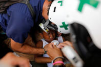 Volunteers members of primary care response team help a child during a rally against President Nicolas Maduro in Caracas, Venezuela May 24, 2017. REUTERS/Carlos Garcia Rawlins