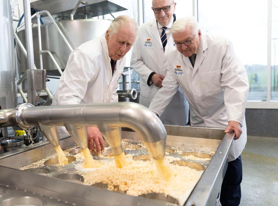 King Charles III helps with the production of cheese during a visit to an organic farm (Getty Images)