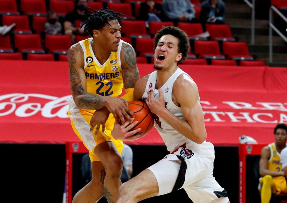 Pittsburgh’s Nike Sibande (22) fouls N.C. State’s Jericole Hellems (4) during the first half of N.C. State’s game against Pittsburgh at PNC Arena in Raleigh, N.C., Sunday, February 28, 2021.