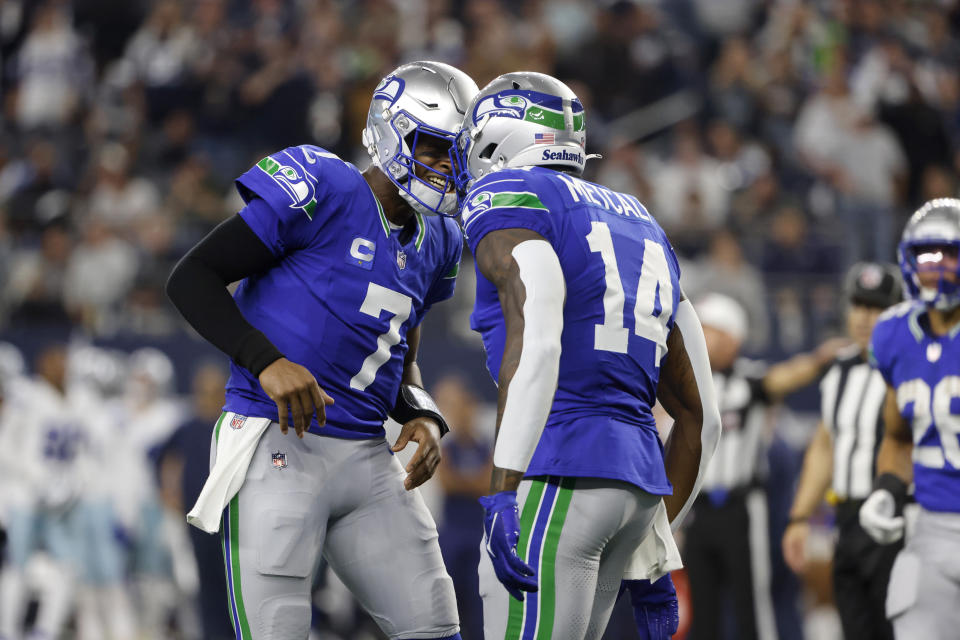 Seattle Seahawks quarterback Geno Smith (7) and wide receiver DK Metcalf (14) celebrate afer Metcalf caught a touchdown pass late in the first half of an NFL football game against the Dallas Cowboys in Arlington, Texas, Thursday, Nov. 30, 2023. (AP Photo/Michael Ainsworth)