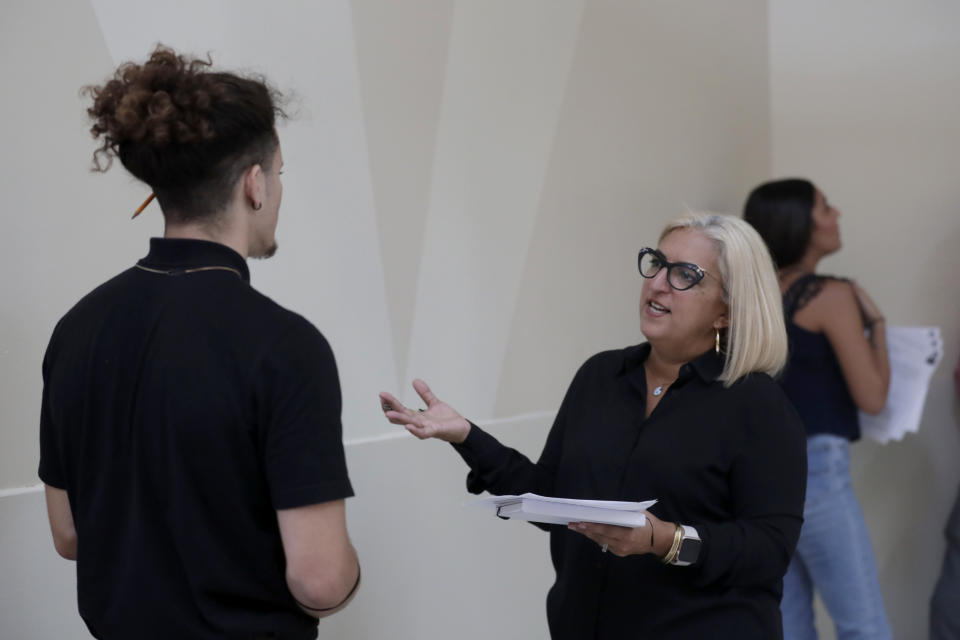 FILE - In this Oct. 1, 2019, file photo, Gory Rodriguez, of Starbucks, right, interviews a job applicant during a job fair at Dolphin Mall in Miami. On Friday, Nov. 1, the U.S. government issues the October jobs report. (AP Photo/Lynne Sladky, File)