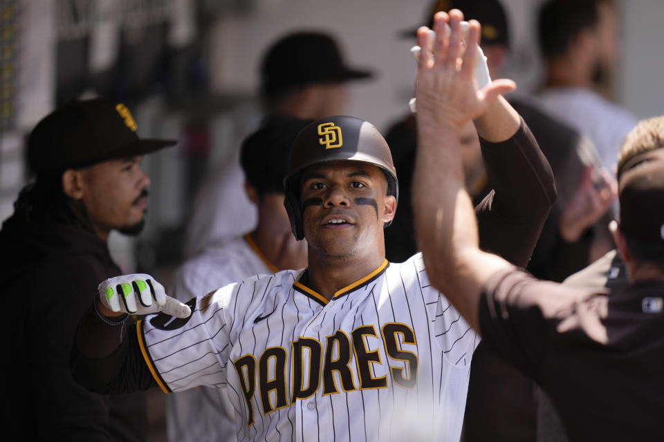 San Diego Padres' Juan Soto celebrates with teammates after hitting a home run during the fourth inning of a baseball game against the Atlanta Braves, Wednesday, April 19, 2023, in San Diego. (AP Photo/Gregory Bull)