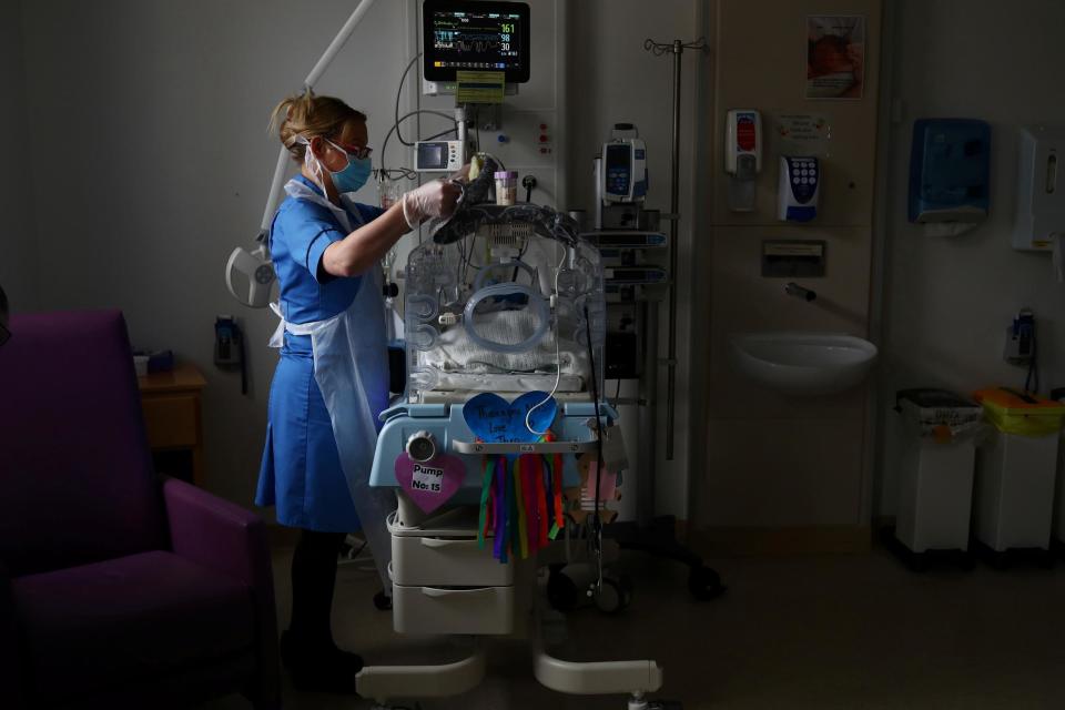 A neonatal nurse cares for a baby at a Lancashire hospital (PA)