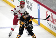Carolina Hurricanes' Jake Guentzel (59) keeps the puck in the zone with Pittsburgh Penguins' Erik Karlsson defending during the first period of an NHL hockey game in Pittsburgh, Tuesday, March 26, 2024. (AP Photo/Gene J. Puskar)